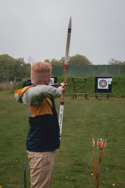 Archer firing arrow. Photo by Aga Lapucha 